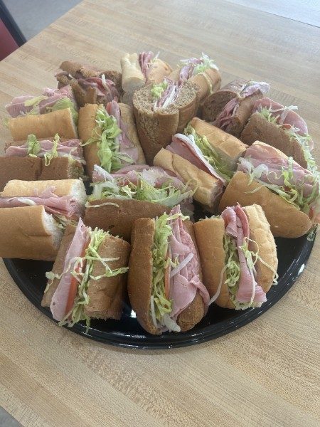 Party tray stacked with sub sandwiches for catering