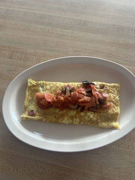 Made-to-order omelet with bacon, onion, and tomato