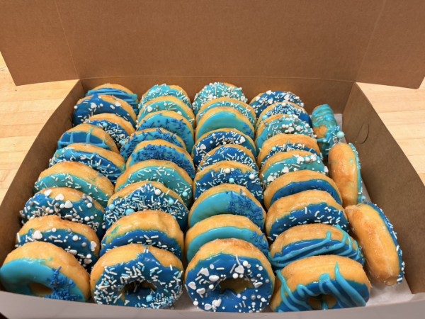 Custom blue-frosted sprinkle donuts by the dozen