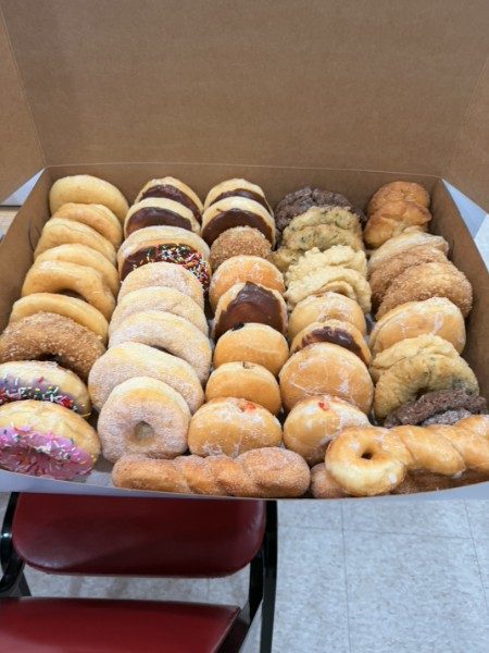 Big box of assorted fresh donuts and fritters